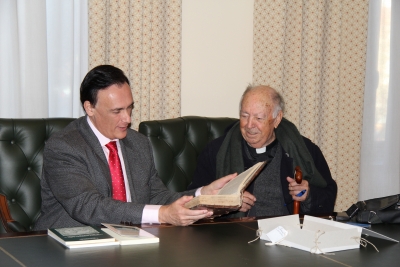 El rector, Jos Carlos Gmez Villamandos, recibe de manos de lvaro Huerga, el volumen ms antiguo de la donacin.